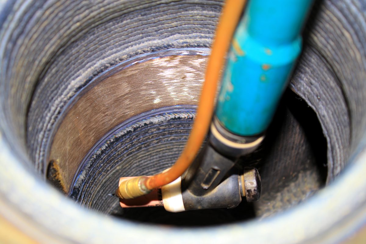 Internal bore of a large pipe showing a completed helical weld overlay bead