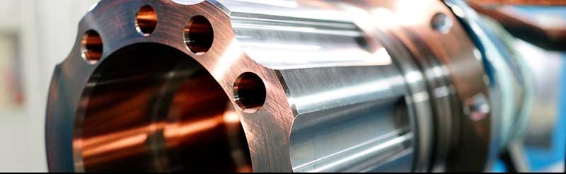 Sectioned pipe coupon showing the clad bore against the carbon steel wall