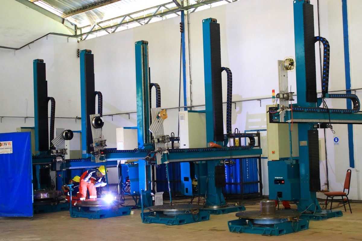 Cladding shop with welder at work