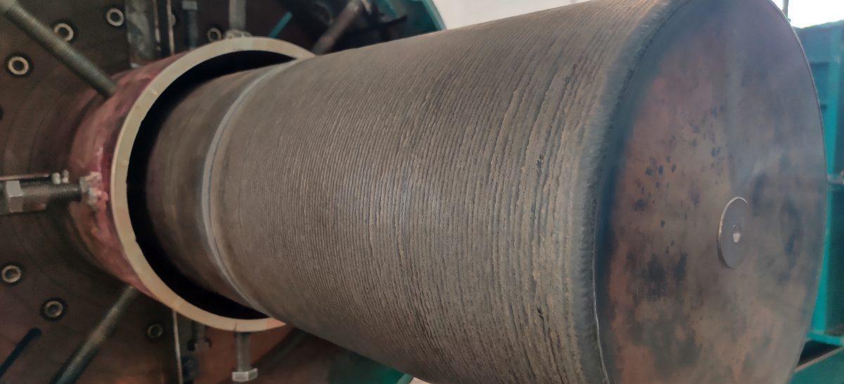Large diameter reducer with a completed weld overlay, mounted on a rotator