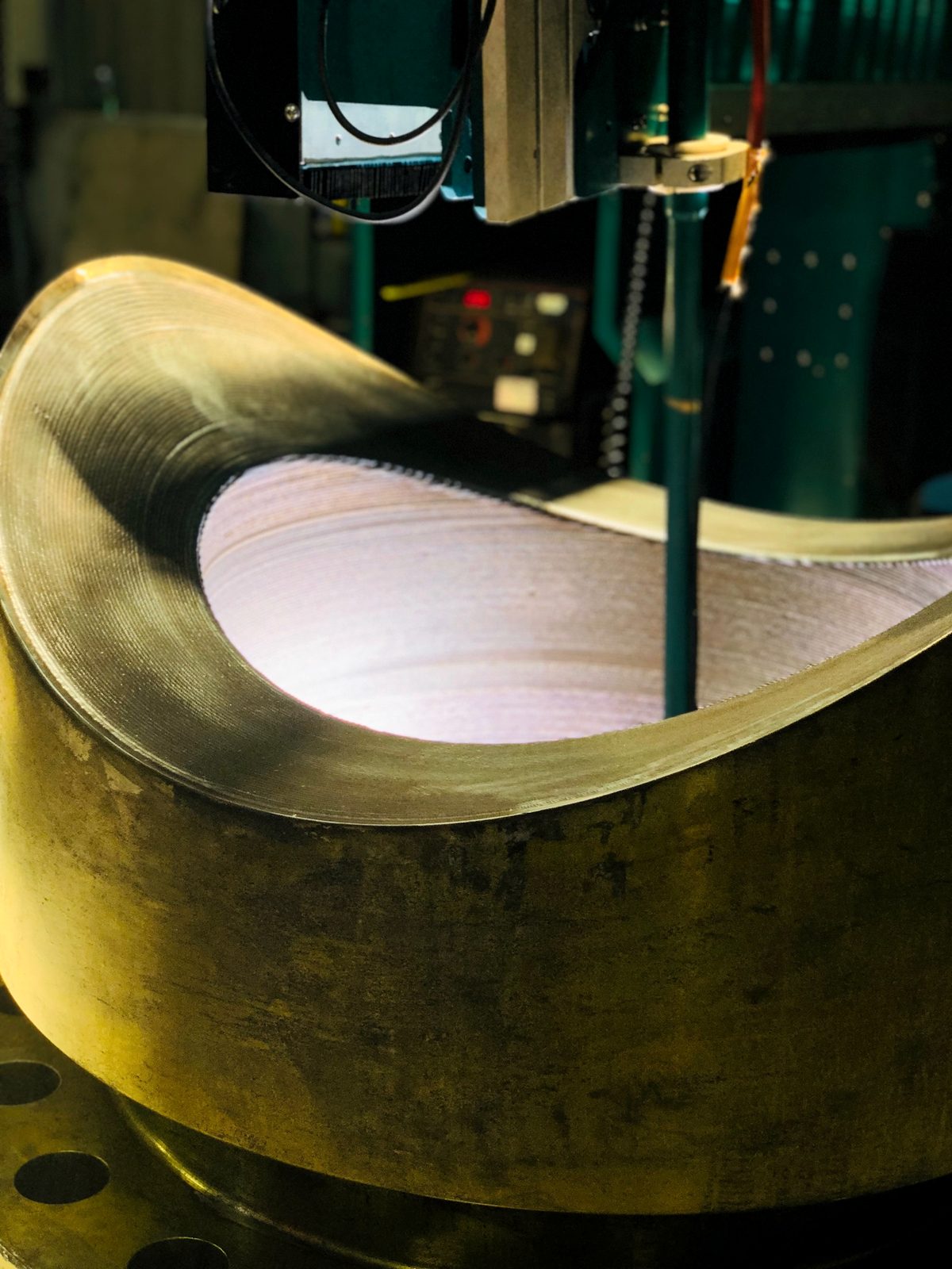 Vessel dished end mounted for weld overlay