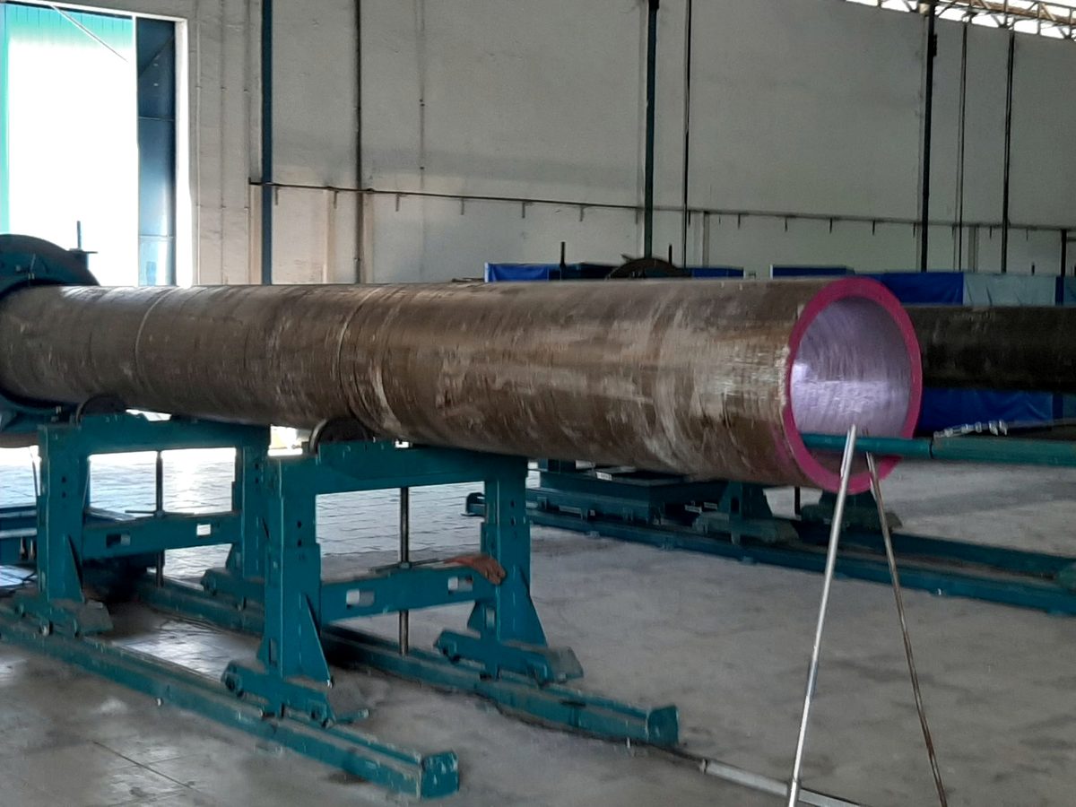 Long pipe supported on turning rolls